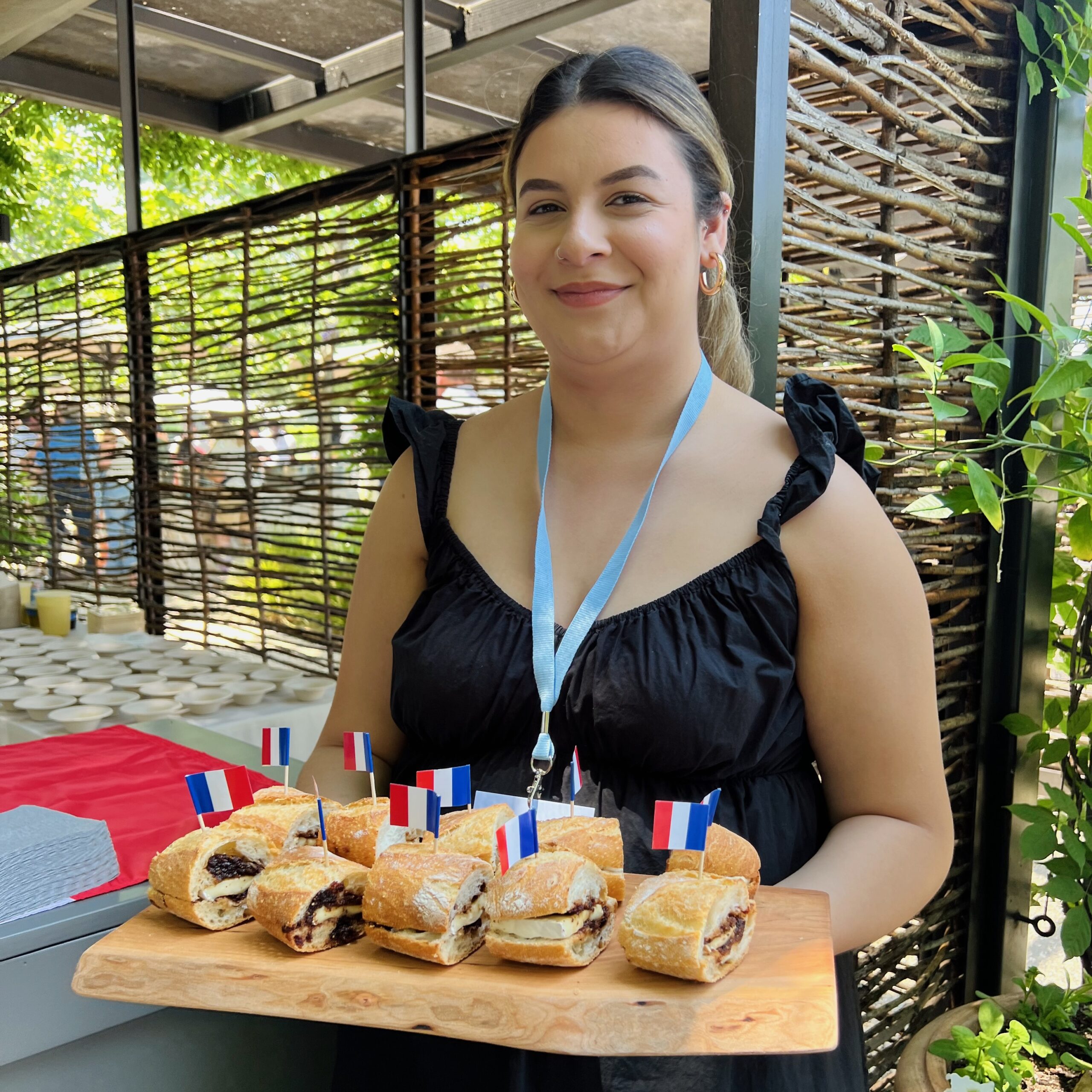 Woman holding tray of sandwiches